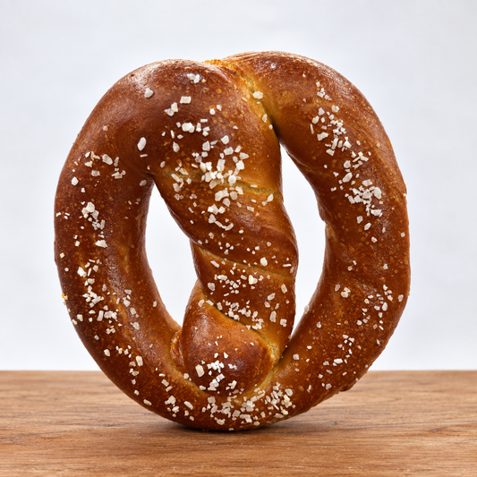 Eric's Pretzels traditional salted soft pretzel on wooden tabletop